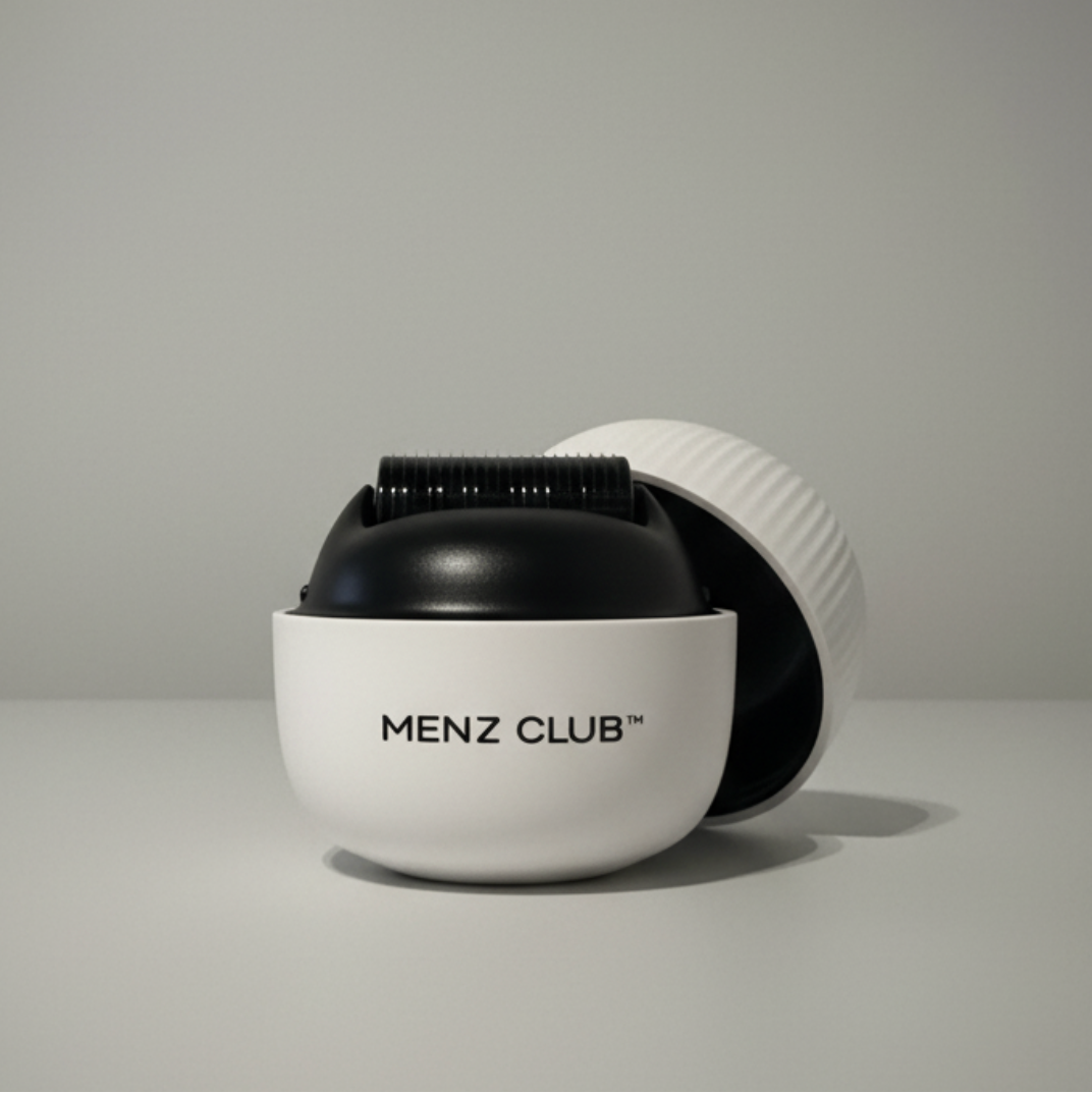 Profile of a man with curly hair and a beaded necklace.