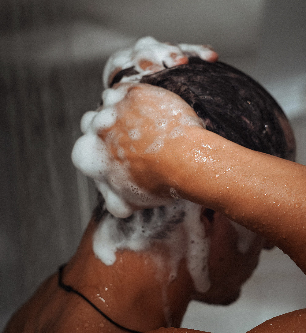 A hand holding a blue beverage can with 'THE ONE AND DONE' text.