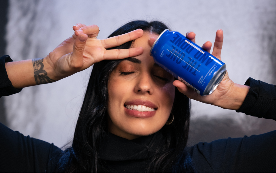 Profile of a man with curly hair, a beard, and a patterned shirt.
